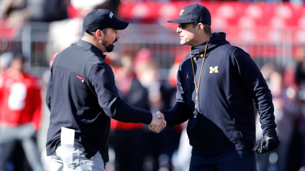 Michigan Wolverines head coach Jim Harbaugh and Ohio State Buckeyes head coach Ryan Day shake hands.